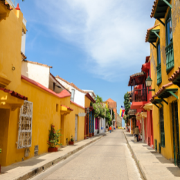 Picture of a colorful street lined with bright buildings under a clear sky